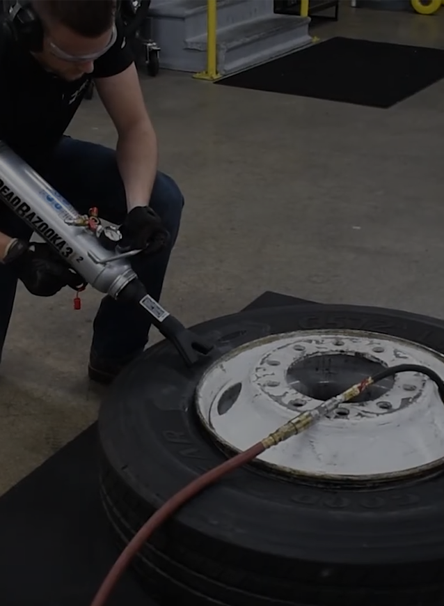 image showing person holding a bead bazooka while inflating a tyre